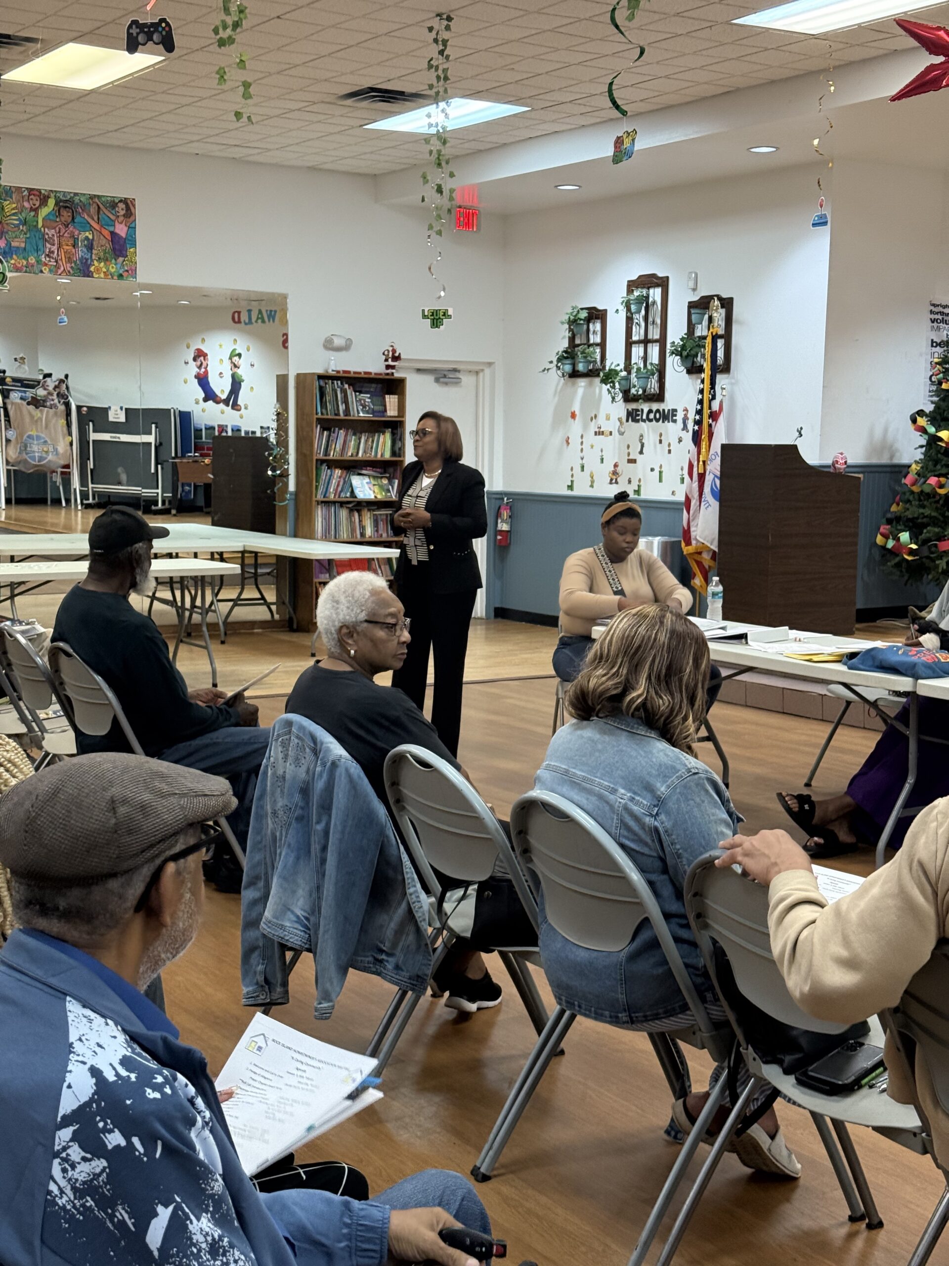 Broward County Tax Collector Abbey Ajayi speaking to residents at the Rock Island HOA meeting about tax collector services and community outreach.
